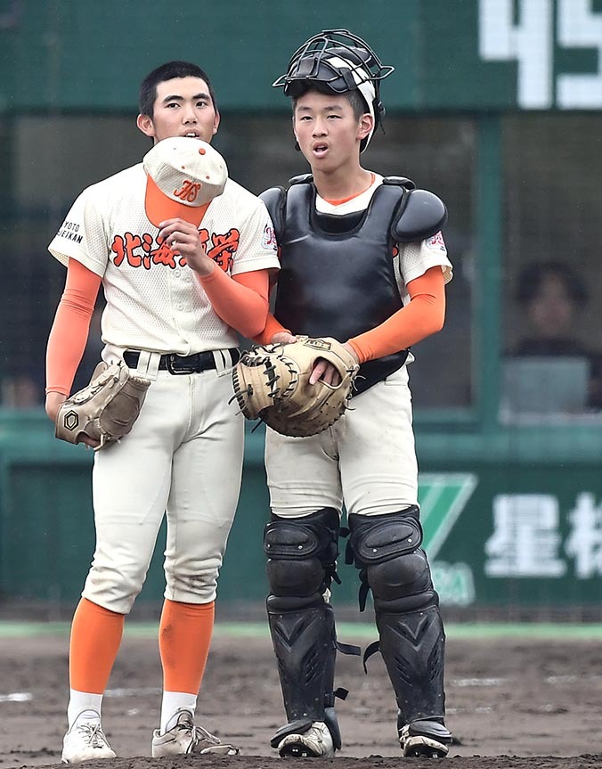 九回、ピンチの場面で平投手(左)に駆け寄り声をかける道栄の高村捕手