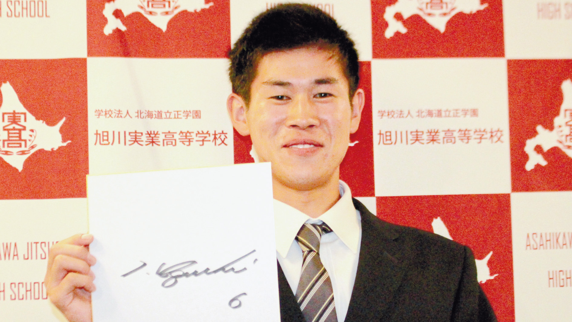 ロッテ・井口監督のサインが書かれた色紙を手に笑顔を見せる田中