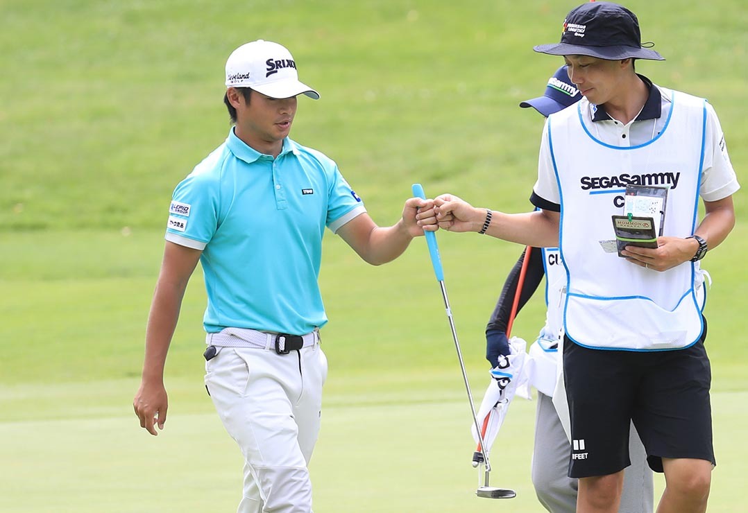 江別出身の片岡(左)は後半11番ホールで、この日6つ目のバーディをゲット。キャディとグータッチを交わす